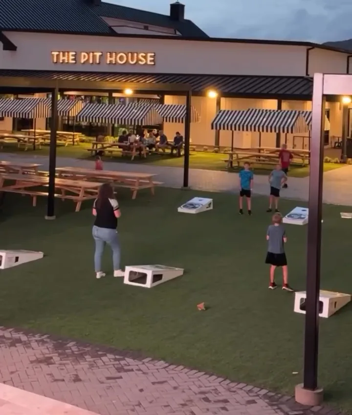 Eating together during a day of indoor family fun near Phoenix at Pecan Lake Entertainment Teens and families playing lawn games at dusk, one of the fun things for teens Phoenix area visitors enjoy near Chandler